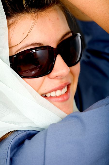 beautiful fashion girl wearing sunglasses over a dark background