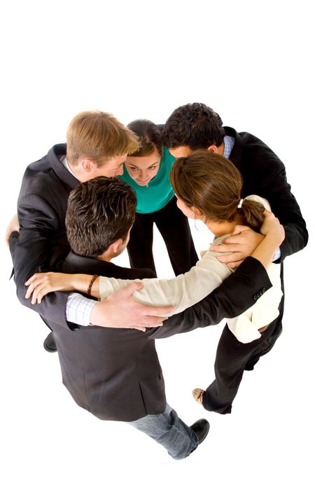 Business team with heads together to convey the concept of teamwork - isolated over a white background