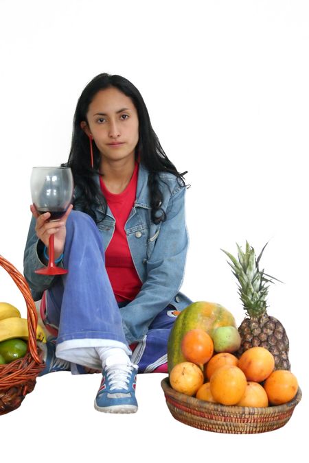 girl drinking with fruits around her