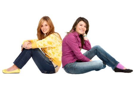 Casual girls sitting on the floor isolated on white