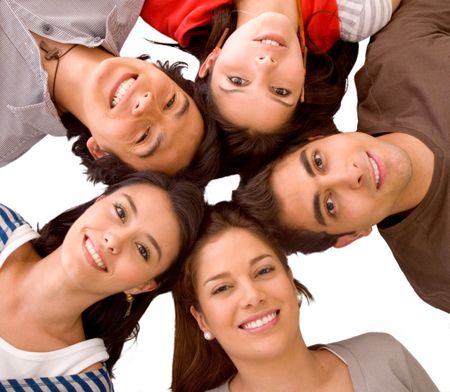 happy group of friends with their heads together on the floor isolated