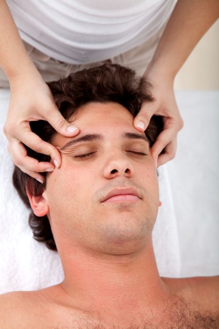 Man getting an anti-stress massage on his face