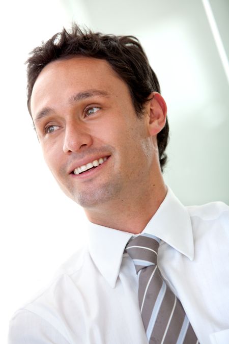 young business man smiling and looking away