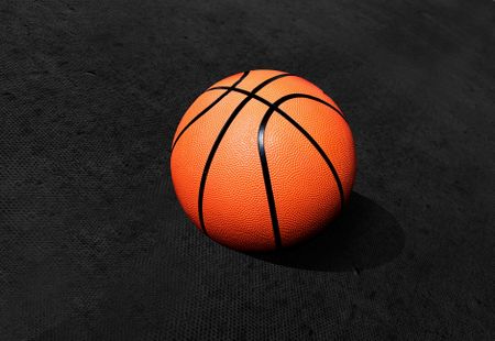 Basketball isolated over a black textured background