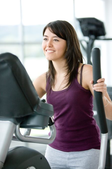 beautiful woman at the gym exercising in the cardio machines