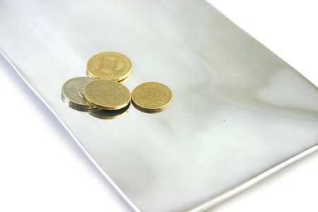 coins on an aluminium tray