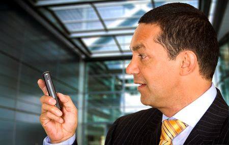 Business man with a mobile phone in a corporate environment