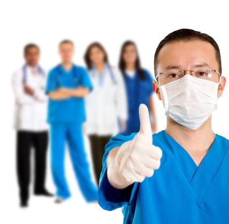 Surgeon with thumbs up and doctors behing him, isolated
