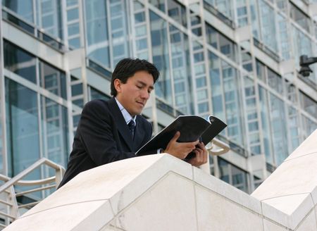 business man reading a magazine in a corporate environment