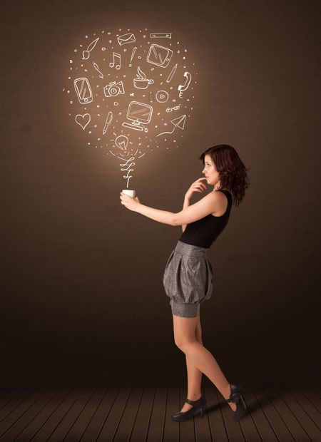 Businesswoman standing and holding a white cup with drown social media icons coming out of the cup