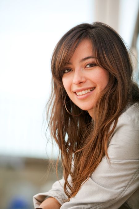 Portrait of a casual woman smiling outdoors