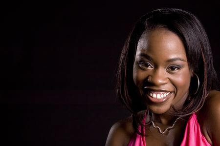 Pretty young African-American woman with big smile, bare shoulders