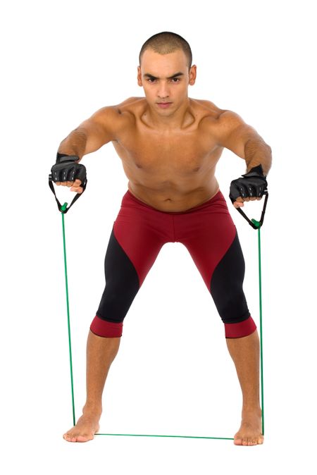 male working out using resistance cords - isolated over a white background