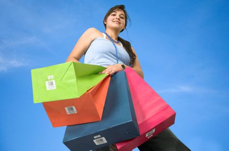 Girl with shopping bags over a blue background