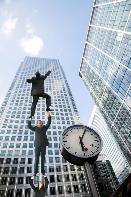 Eccentirc business people climbing a corporate building