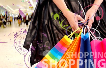 female hands holding shopping bags in a mall