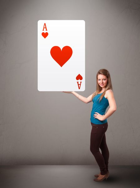 Beautifu young woman holding a red heart ace
