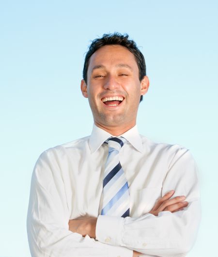 Happy business man smiling over a blue background