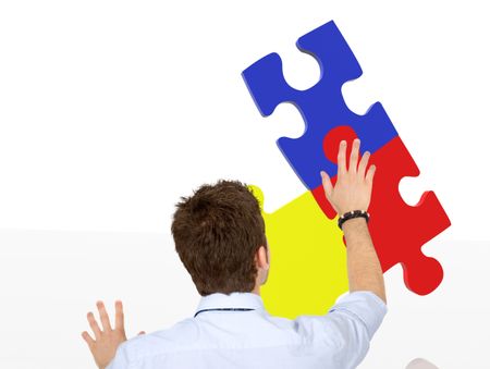 business man making a jigsaw puzzle isolated