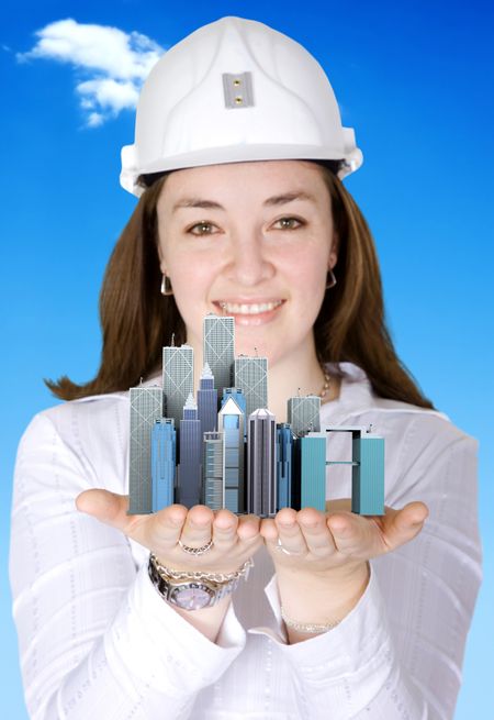 female architect smiling holding a city in her hands