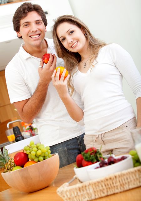 Beautiful healthy eating couple with fruits and vegetables