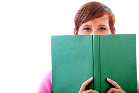 Young woman covering her face with a book isolated