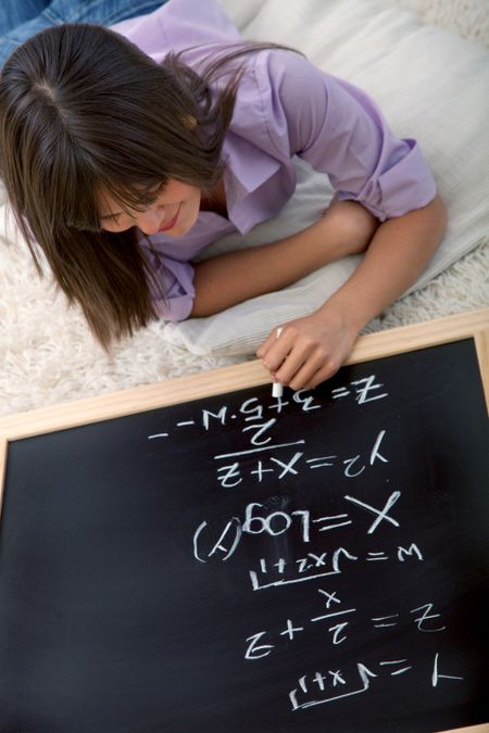 Young woman studying maths with a chalkboard