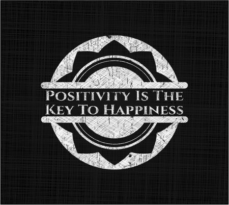 Positivity Is The Key To Happiness chalkboard emblem on black board