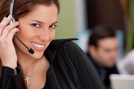 Customer support operator in an office smiling