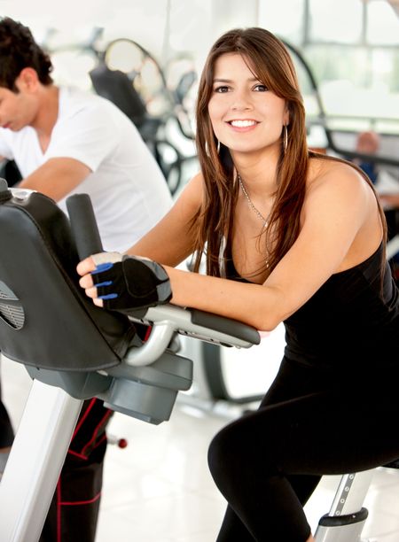 Beautiful woman exercising at the gym and smiling