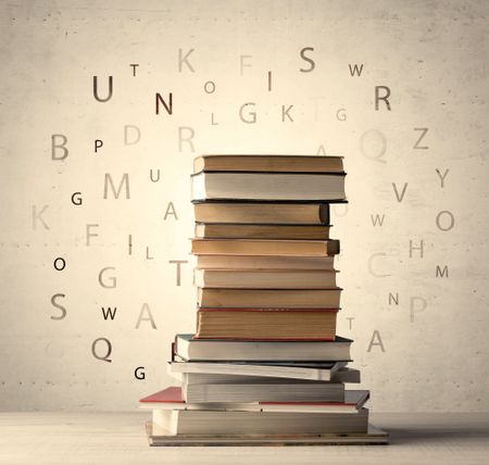 Books with flying letters on vintage old background