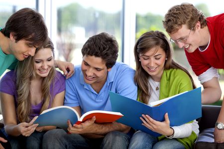 Group of people studying with books smiling