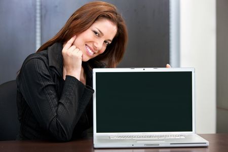 Woman portrait with a laptop computer at an office