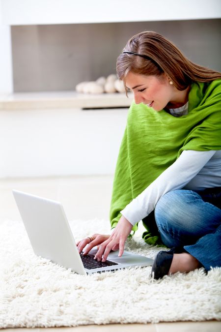 Casual woman browsing on a laptop indoors