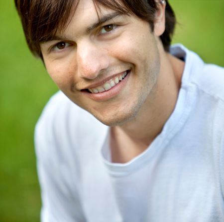 Portrait of a handsome young male outdoors smiling