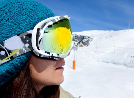 female skier wearing ski glasses at the ski piste