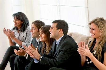 Happy business group applauding at the office
