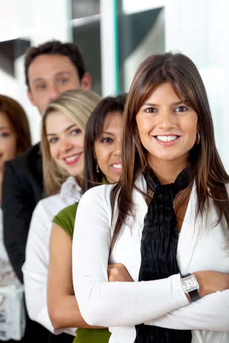 Business woman smiling leading a team at the office
