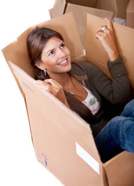 Pretty woman smiling inside a box isolated on white