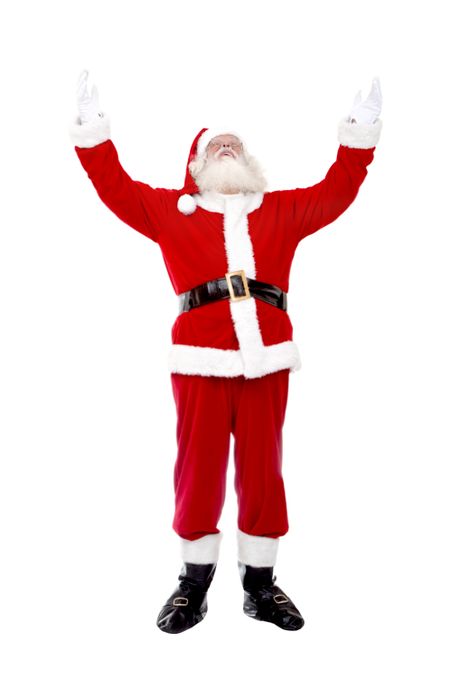 Happy Santa Claus with arms outstretched isolated over a white background