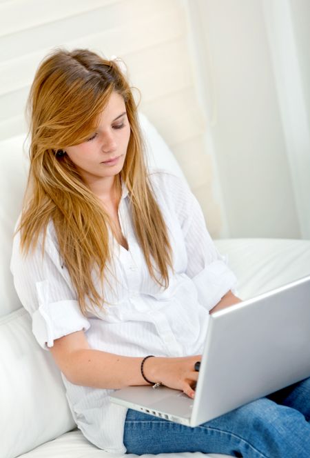 Young girl at home with a laptop