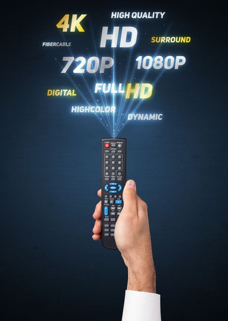 Hand holding a remote control, multimedia properties coming out of it

