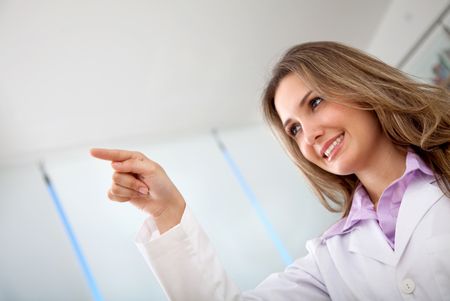 Female doctor smiling and pointing at something