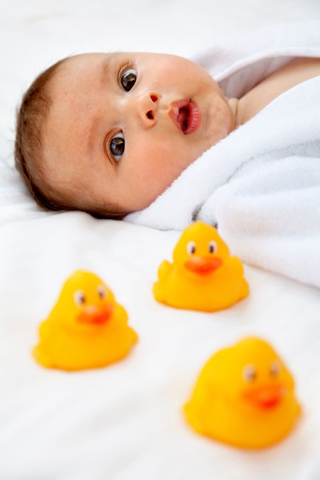 Portrait of a beautiful peaceful baby boy with ducks