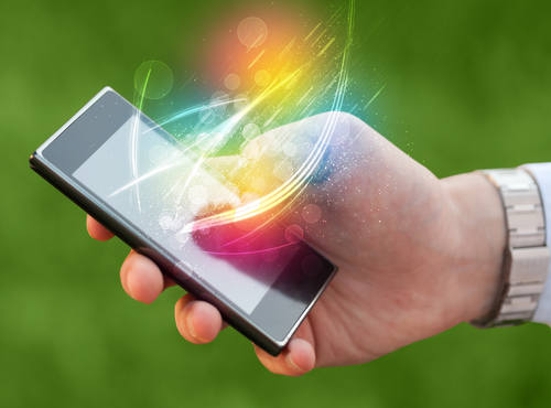 Hand holding smart phone with abstract glowing lines concept
