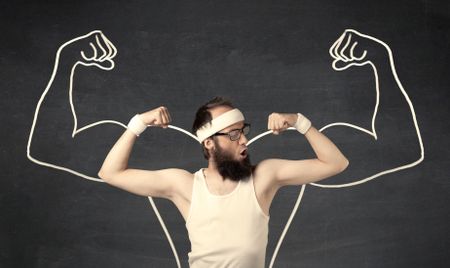 A young male with beard and glasses posing in front of grey background, thinking about lifting weight with big muscles, illustrated by white drawing concept.