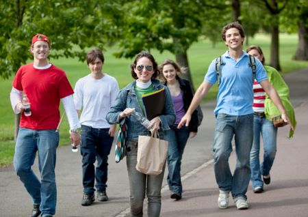 Group of young people walking outdoors and smiling