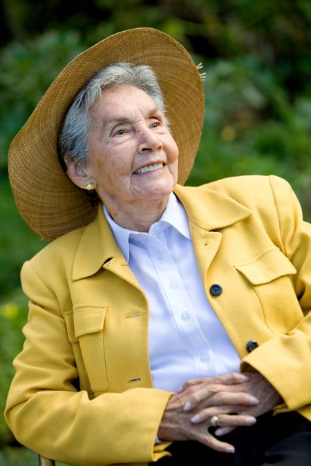 Beautiful elder woman with a hat outdoors