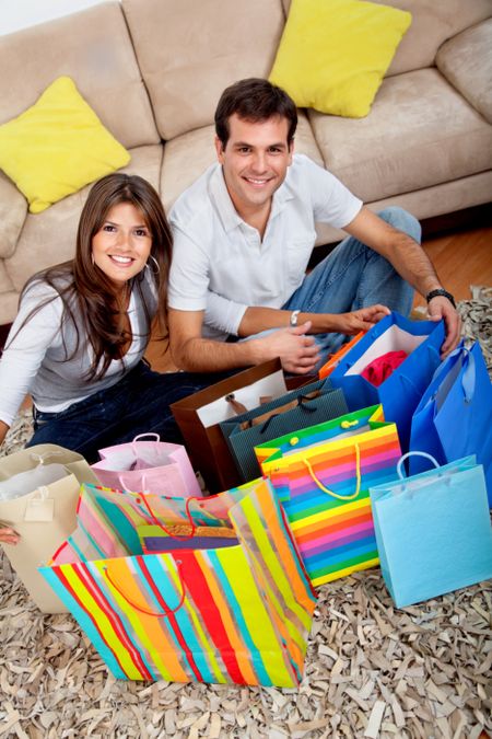 Shopping couple at home looking at the purchases