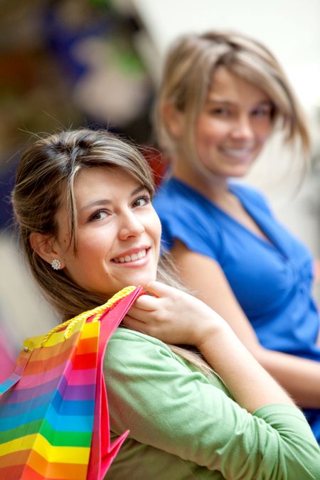 Beautiful shopping girls with bags and smiling